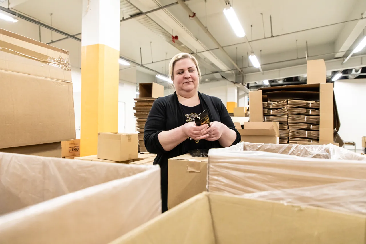 A Nordic BioCosmetic employee packing finished products at the Tuusula factory